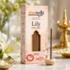 Harimodini Lily of the Valley bambooless dhoop sticks box with transparent golden window, visible dhoop sticks, free ceramic holder, and burning dhoop stick.
