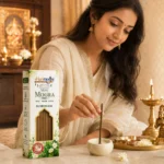 Devotional Indian woman with idol with Harimodini Moti Mogra dhoop sticks box and burning dhoop holder.